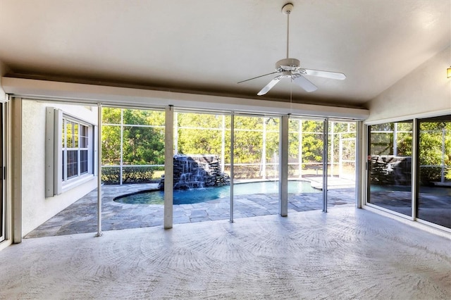 unfurnished sunroom with lofted ceiling and ceiling fan