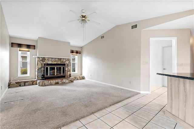 unfurnished living room with visible vents, ceiling fan, vaulted ceiling, and baseboards