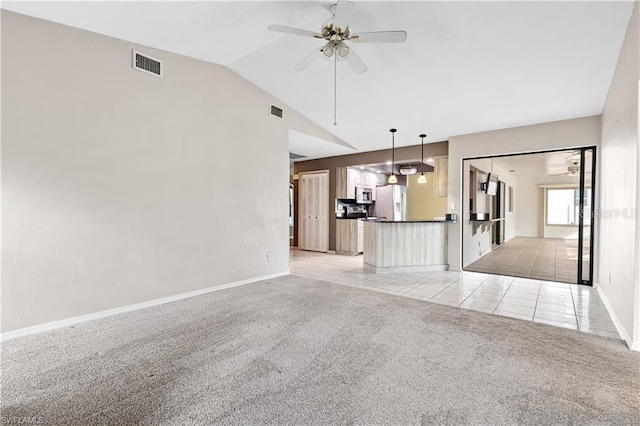 unfurnished living room featuring visible vents, ceiling fan, light colored carpet, and vaulted ceiling