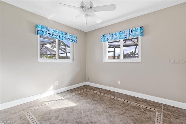 tiled spare room featuring baseboards and a ceiling fan