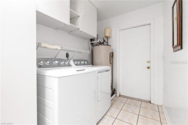 clothes washing area featuring light tile patterned flooring, water heater, laundry area, and washing machine and dryer