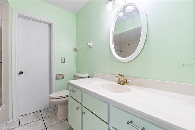 bathroom with toilet, tile patterned flooring, and vanity