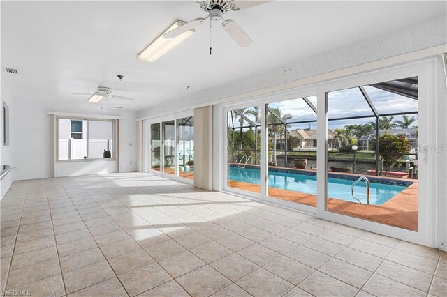 unfurnished sunroom featuring a pool, visible vents, and a ceiling fan