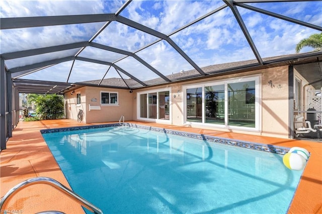 pool with a patio and glass enclosure
