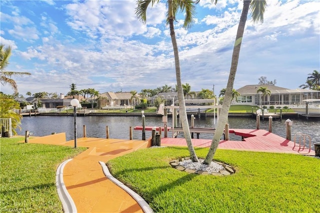 view of dock featuring a residential view, a lawn, and a water view