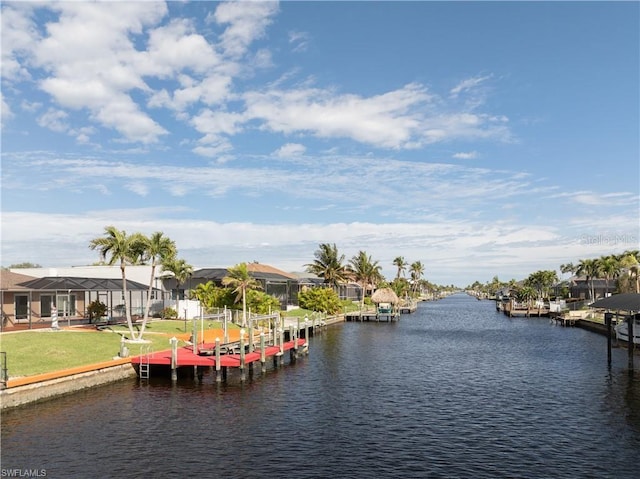 view of dock featuring boat lift, a residential view, a water view, and a lawn