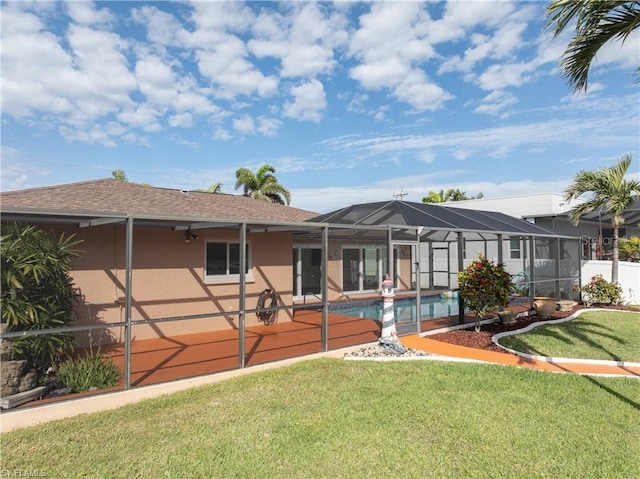 rear view of house featuring stucco siding, a yard, a shingled roof, glass enclosure, and an outdoor pool