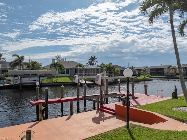 view of dock with a residential view, a water view, and boat lift
