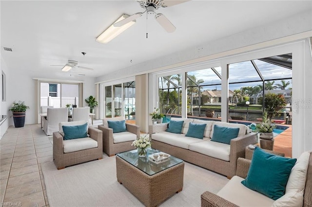 sunroom / solarium featuring ceiling fan, a healthy amount of sunlight, and an outdoor hangout area