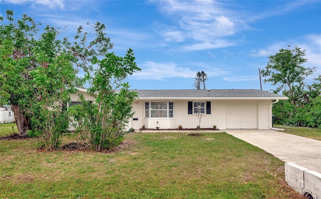 ranch-style house with concrete driveway and a front yard