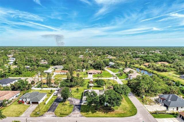 birds eye view of property featuring a residential view, a forest view, and a water view