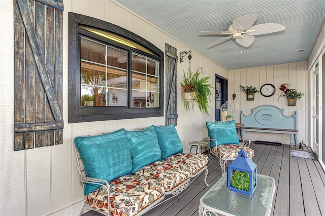 wooden terrace with a porch and ceiling fan