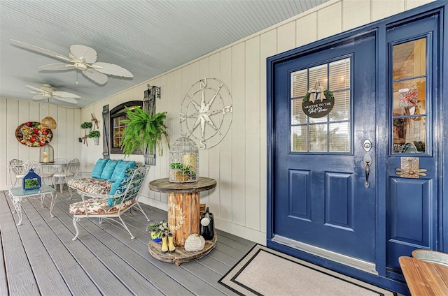 property entrance with covered porch and ceiling fan