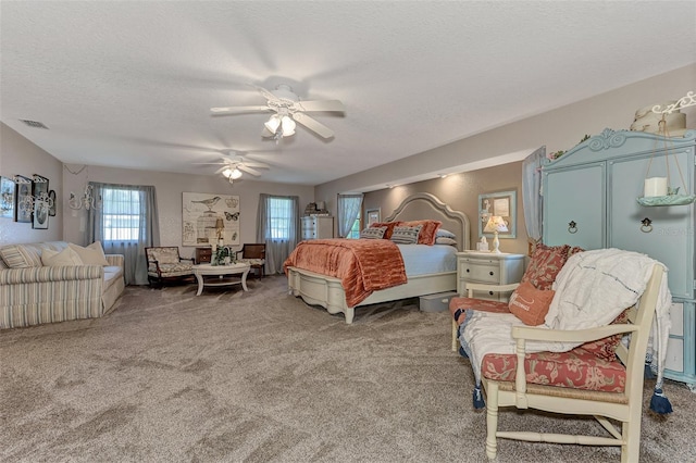 bedroom with visible vents, carpet, ceiling fan, and a textured ceiling