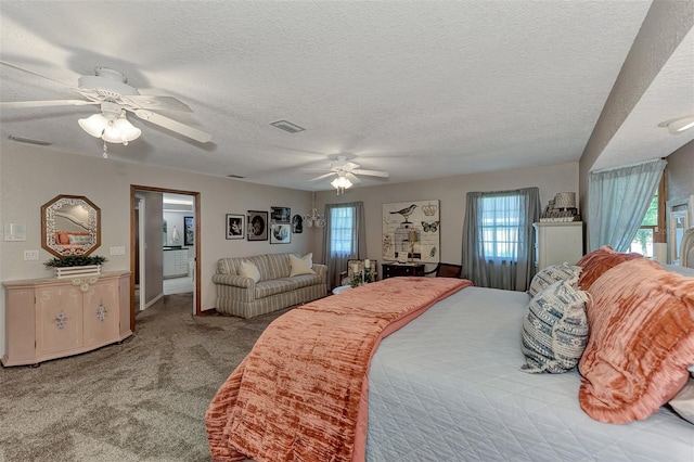 bedroom with visible vents, carpet flooring, a textured ceiling, and ceiling fan