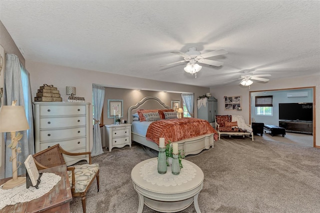 bedroom with ceiling fan, a wall unit AC, carpet, and a textured ceiling