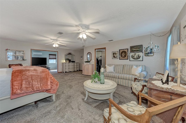 interior space with visible vents, ceiling fan, a textured ceiling, and carpet