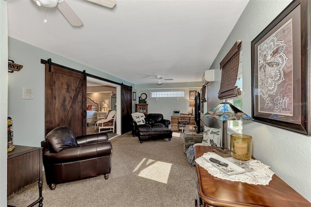 carpeted living area with a ceiling fan, a wall mounted AC, a barn door, and a textured wall