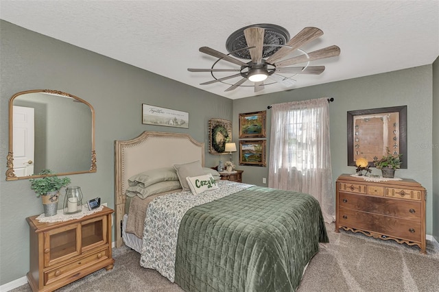 bedroom with a textured ceiling, ceiling fan, and carpet flooring