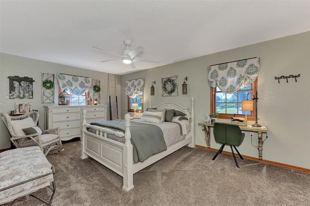 carpeted bedroom with a textured ceiling, a ceiling fan, and baseboards