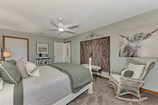 bedroom featuring carpet, baseboards, and a textured ceiling