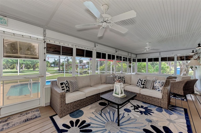 sunroom / solarium featuring plenty of natural light and ceiling fan