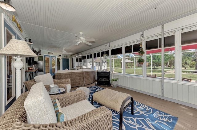 sunroom featuring ceiling fan