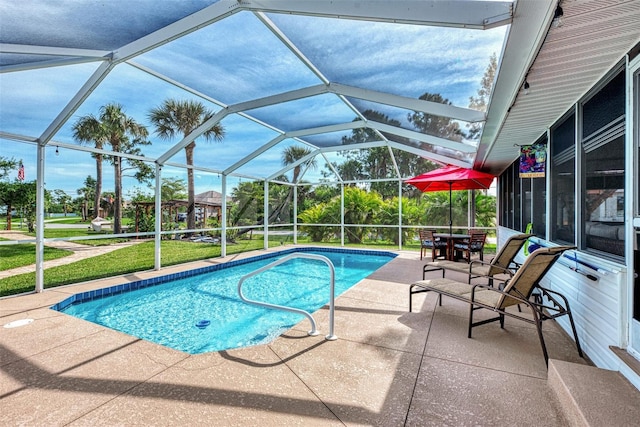 pool featuring a lanai and a patio area