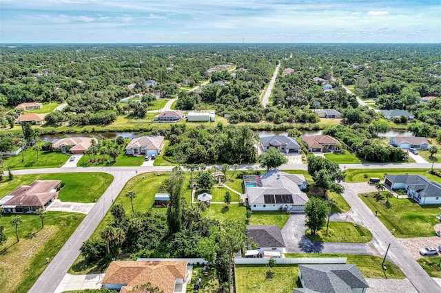 aerial view featuring a residential view and a wooded view