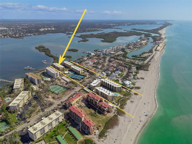 drone / aerial view featuring a beach view and a water view