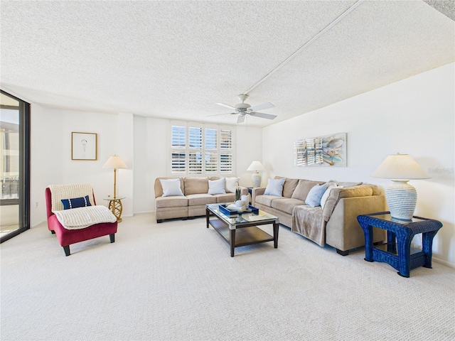 carpeted living area featuring a textured ceiling and ceiling fan
