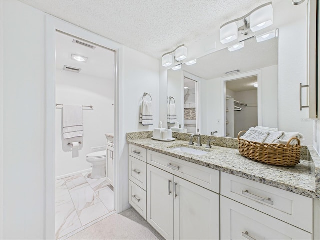 bathroom with visible vents, toilet, vanity, marble finish floor, and a textured ceiling