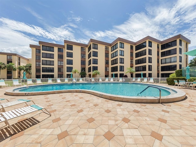 community pool featuring a patio and fence