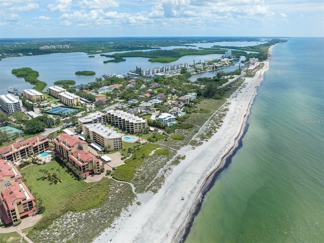 birds eye view of property with a water view and a beach view