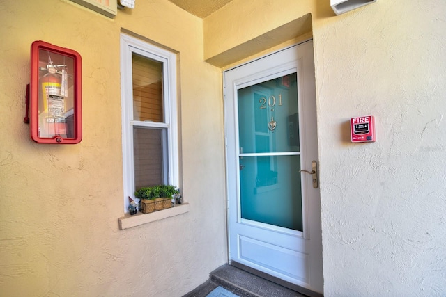 entrance to property with stucco siding