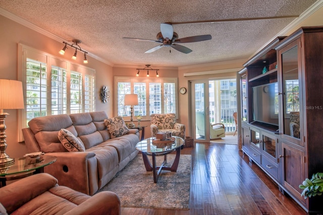 living room featuring a ceiling fan, a textured ceiling, dark wood-style flooring, and crown molding