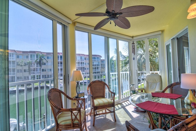 sunroom featuring a wealth of natural light and ceiling fan