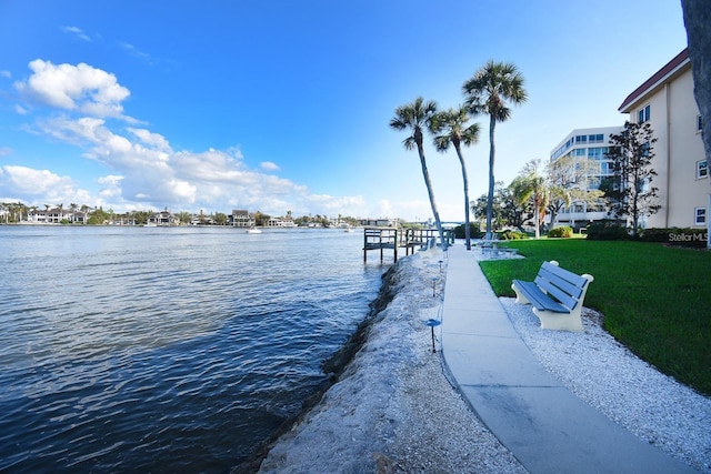 dock area featuring a water view and a lawn