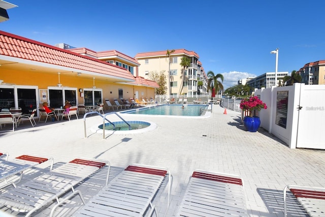 community pool featuring a patio area and fence