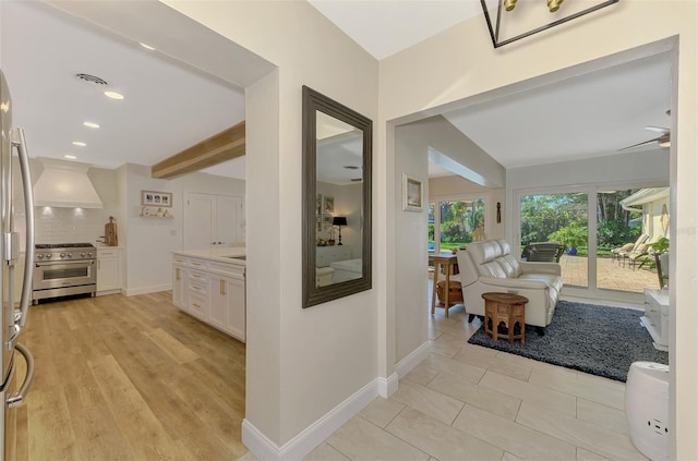 hallway featuring light wood finished floors, visible vents, baseboards, beam ceiling, and recessed lighting