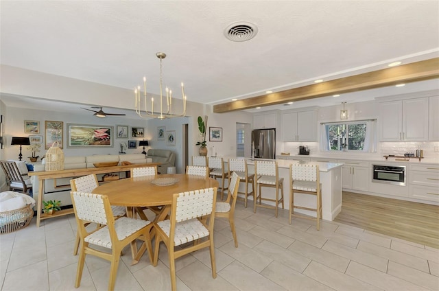 dining space featuring visible vents, beam ceiling, ceiling fan with notable chandelier, recessed lighting, and light tile patterned floors