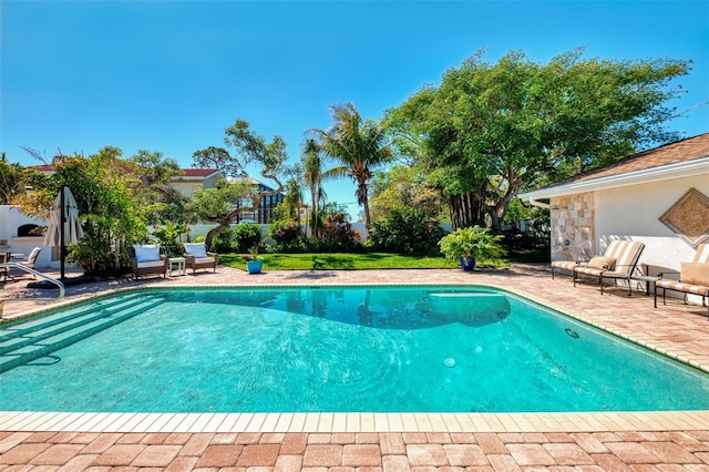 outdoor pool with a patio area