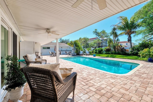 outdoor pool featuring a patio area and a ceiling fan