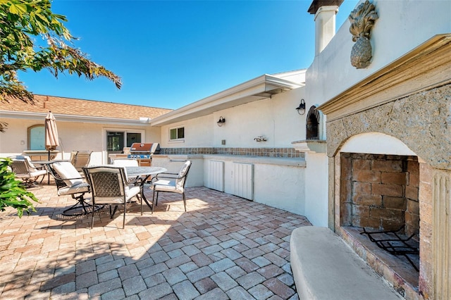 view of patio with outdoor dining area, grilling area, and an outdoor kitchen