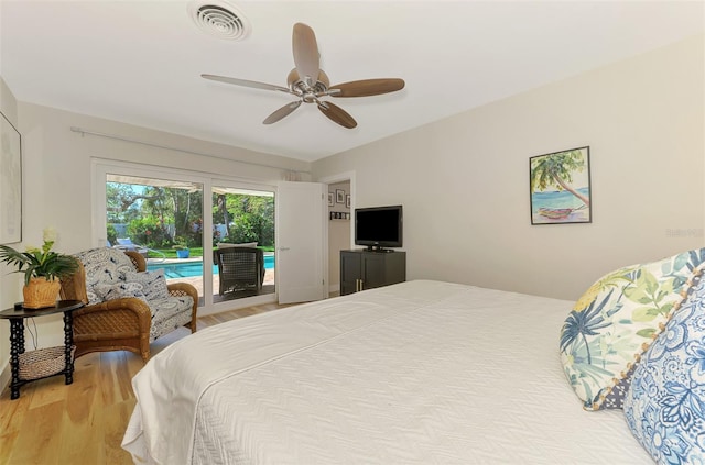 bedroom featuring access to exterior, wood finished floors, visible vents, and ceiling fan