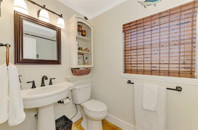 bathroom with toilet and baseboards