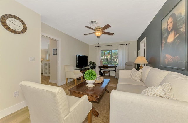 living area with light wood-type flooring, baseboards, visible vents, and a ceiling fan