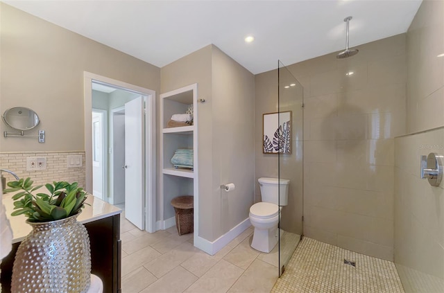 full bath with toilet, tile patterned flooring, baseboards, walk in shower, and vanity