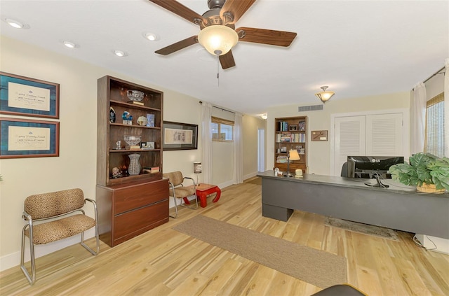 interior space featuring visible vents, a healthy amount of sunlight, light wood-style floors, and ceiling fan