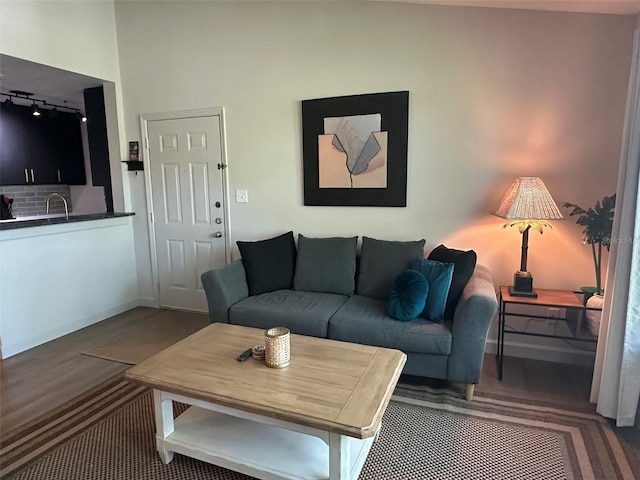 living room featuring track lighting and baseboards